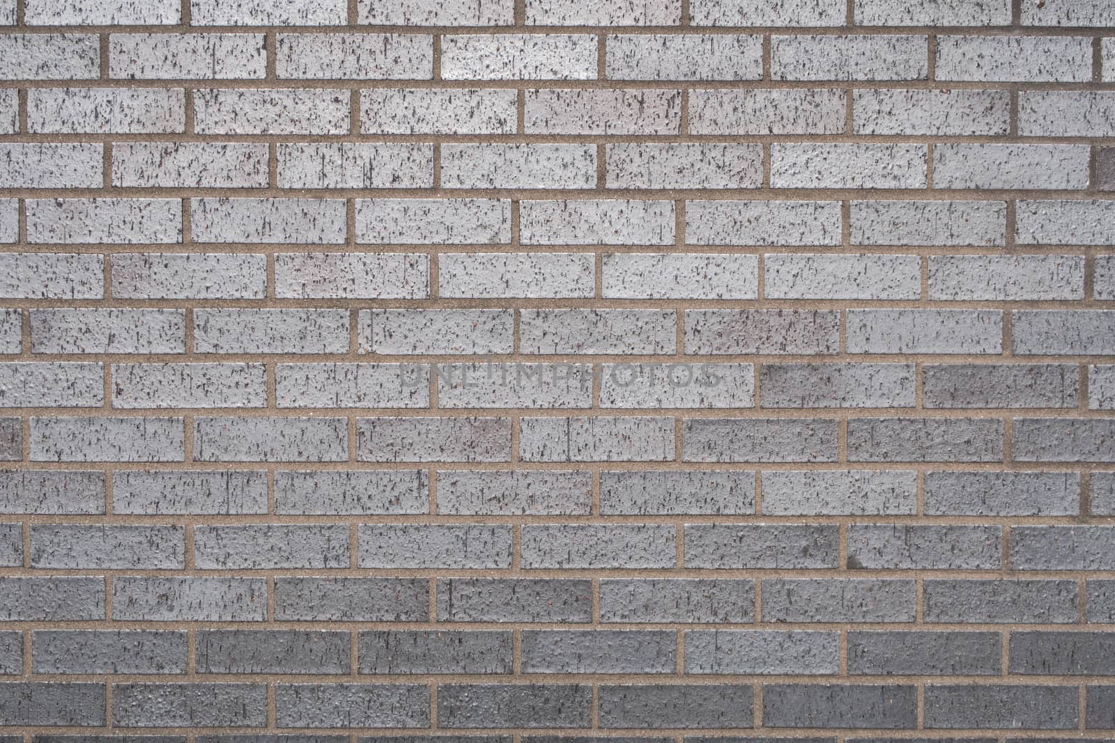 Texture of grey bricks with blue metallic reflects