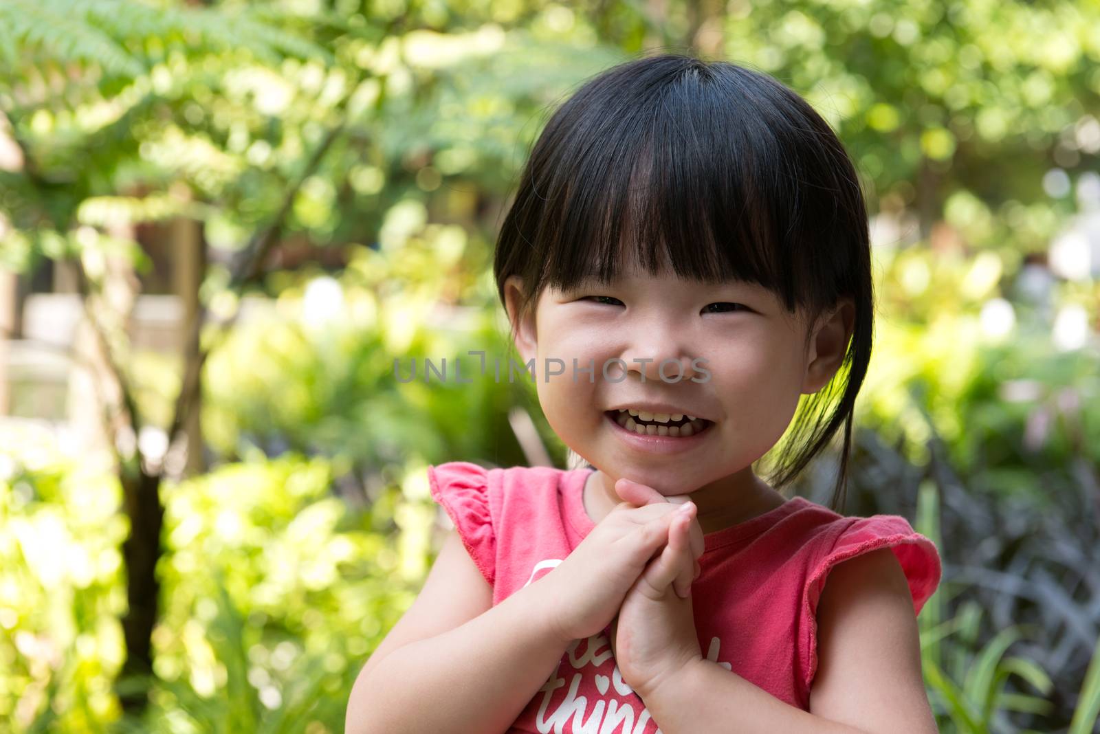 Portrait of beautiful asian child girl in outdoor park