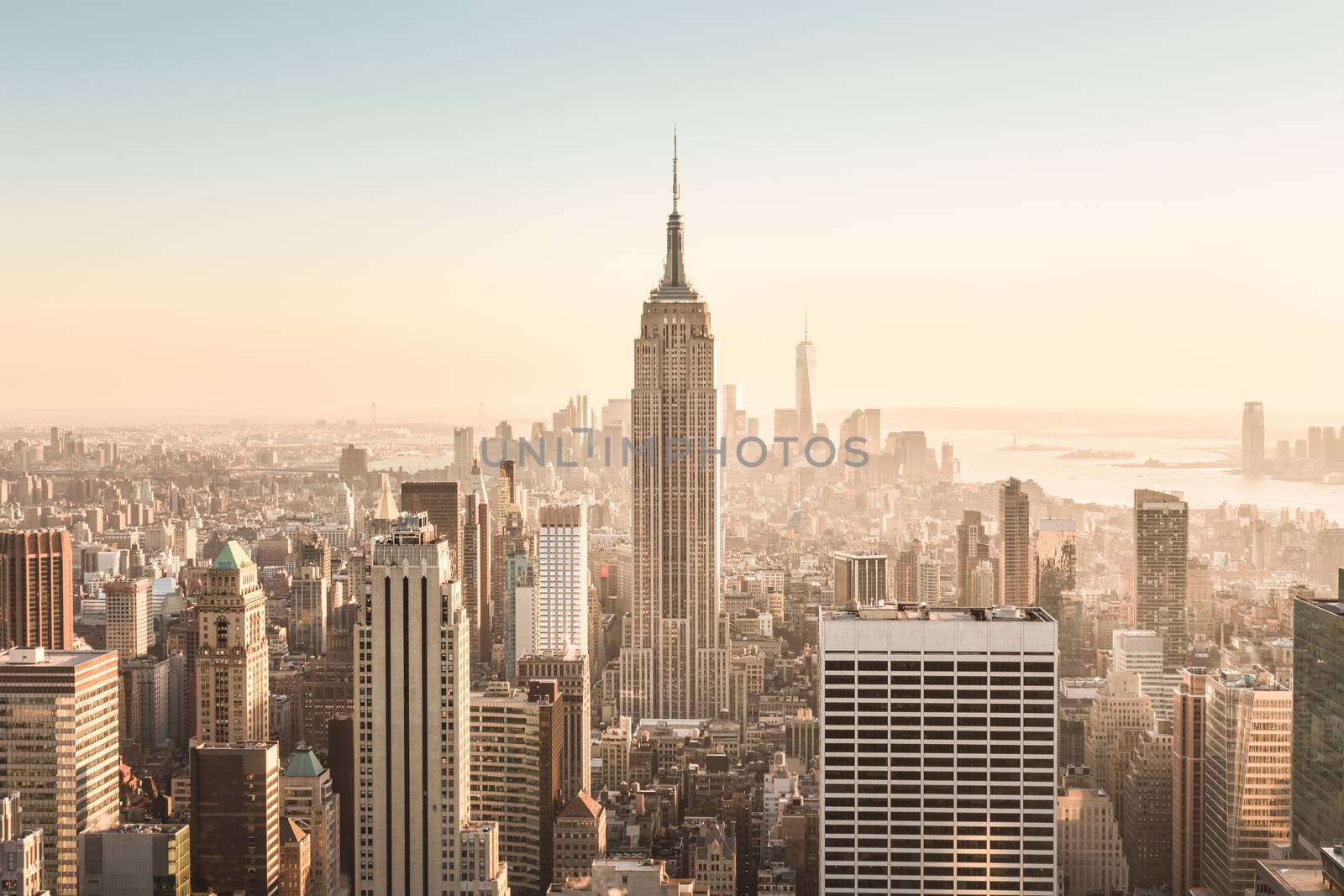 New York City. Manhattan downtown skyline with illuminated Empire State Building and skyscrapers at sunset. USA.