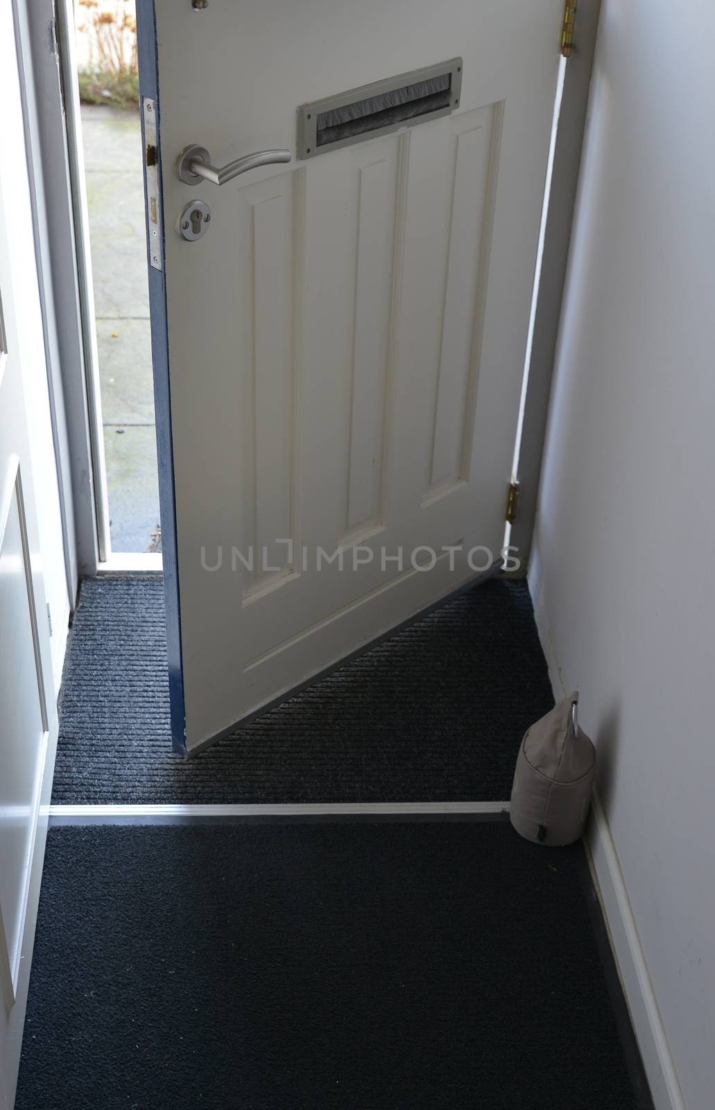 front door of house open with view on the street