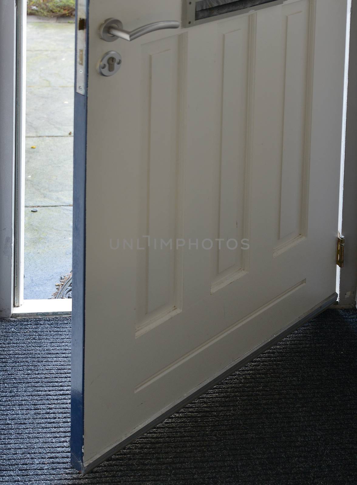 front door of house open with view on the street