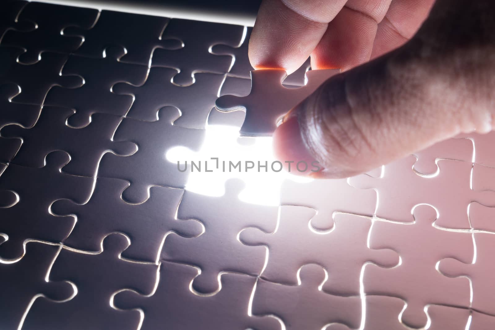 Male or Man Hand and Finger put Piece of Jigsaw in Place to Solve or Match Puzzle as Business Solution