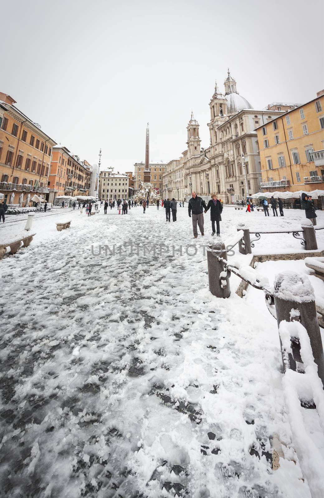 Piazza Navona in Rome covered with snow with citizens and tourists walking in wonder after the unusual snowfall of February 26th 2018 by rarrarorro