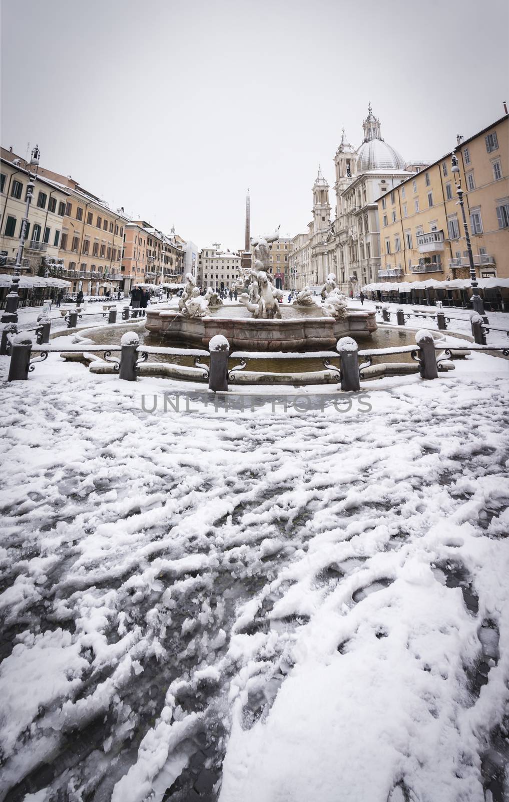 Piazza Navona in Rome covered with snow with citizens and tourists walking in wonder after the unusual snowfall of February 26th 2018 by rarrarorro