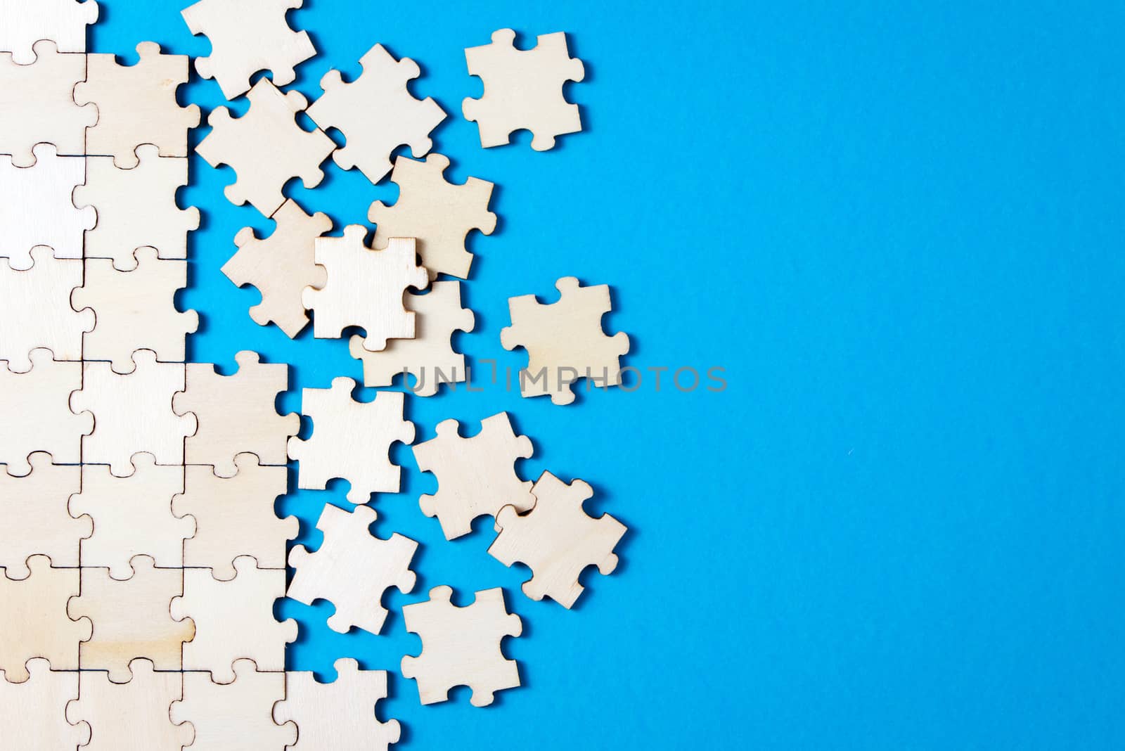 Blue background made from white puzzle pieces and place for your content