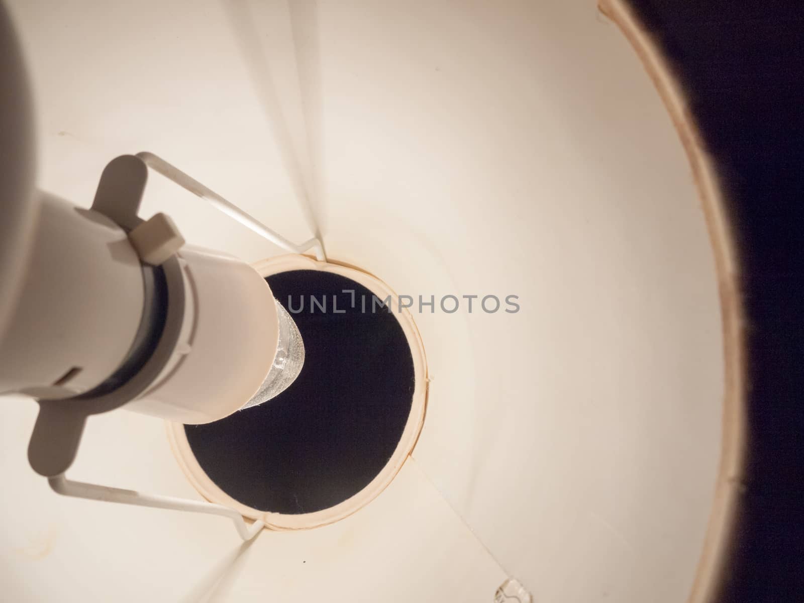 close up of lamp bulb in bedside white table lamp; essex; england; uk
