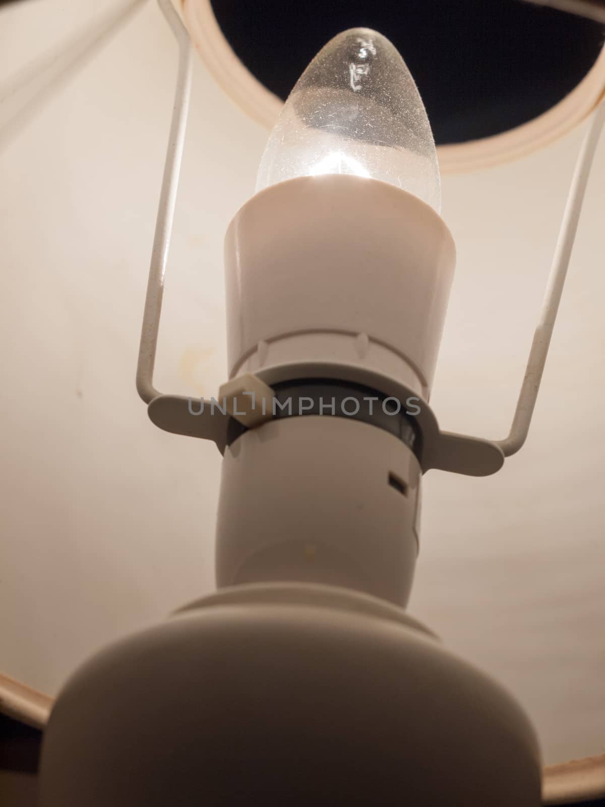 close up of lamp bulb in bedside white table lamp; essex; england; uk