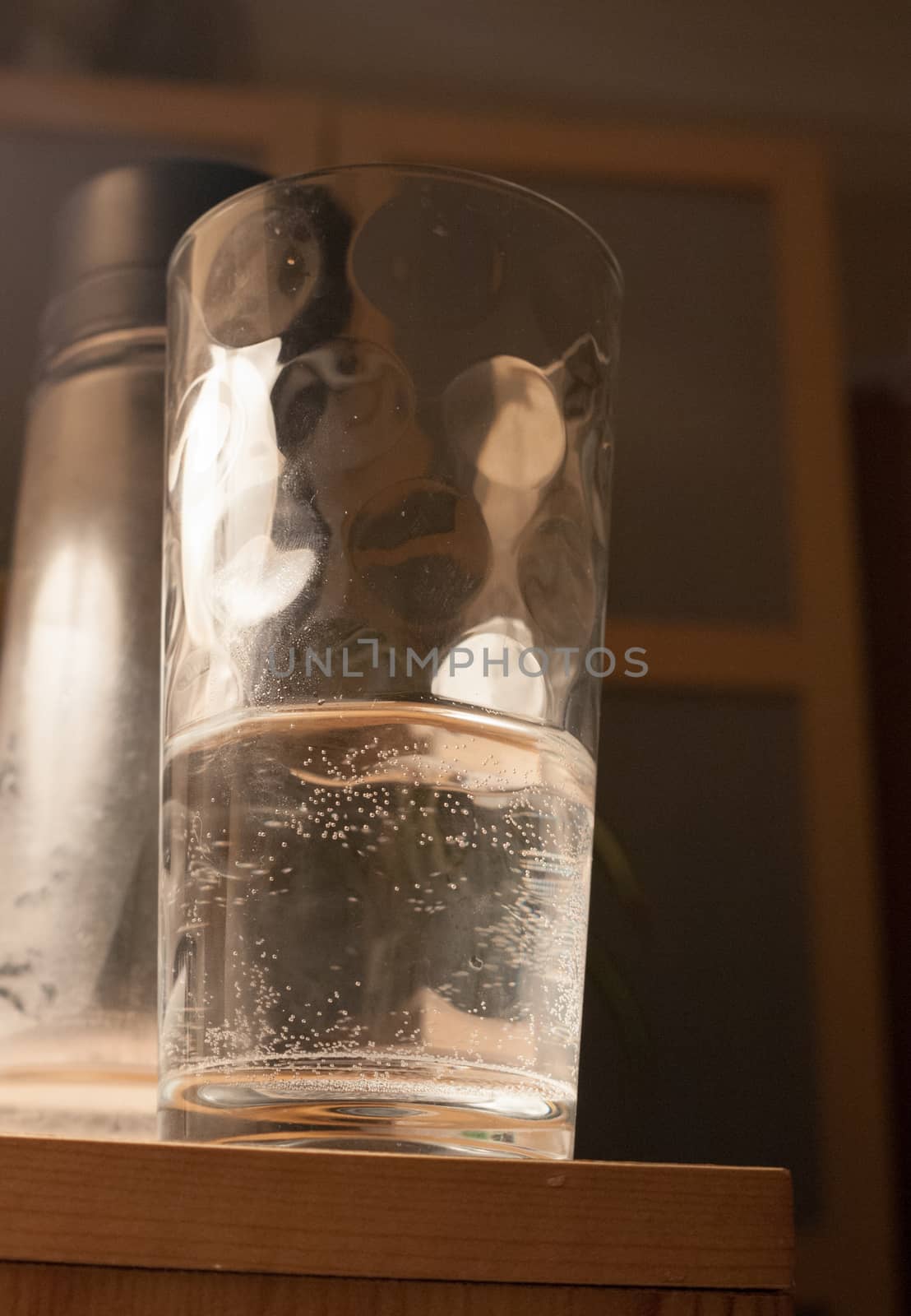 close up of half filled glass of water on side ; essex; england; uk