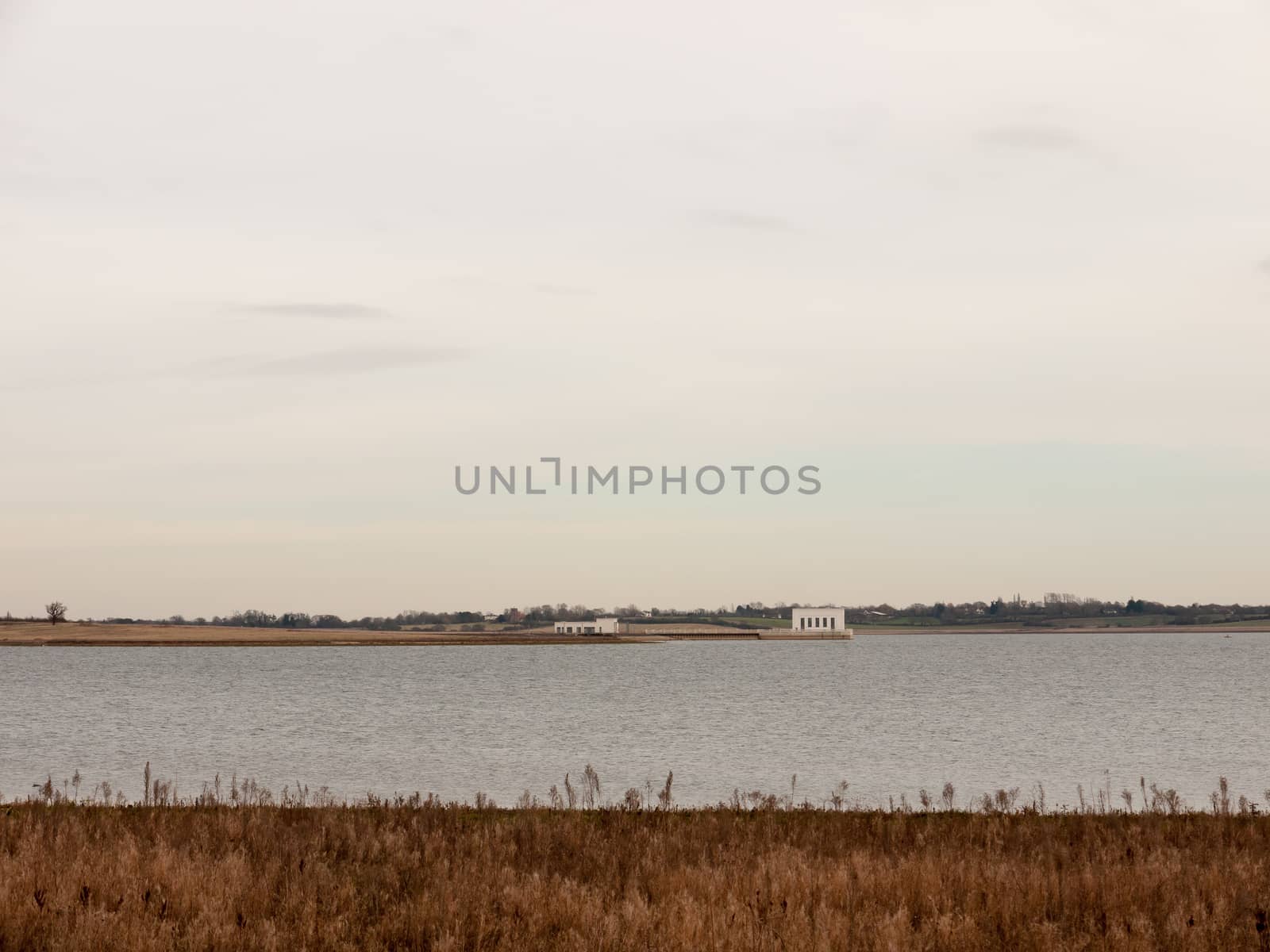 open sea coast plain with grass in front horizon overcast clear calm; essex; england; uk