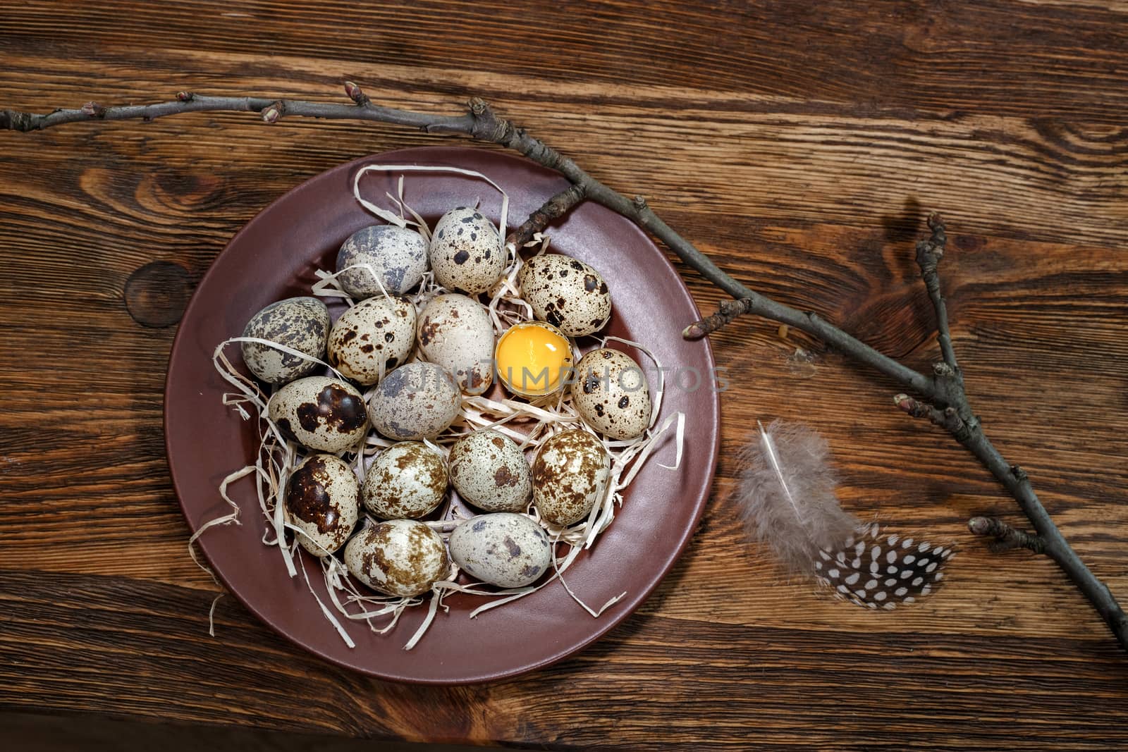 fresh quail eggs in a plate on a wooden background