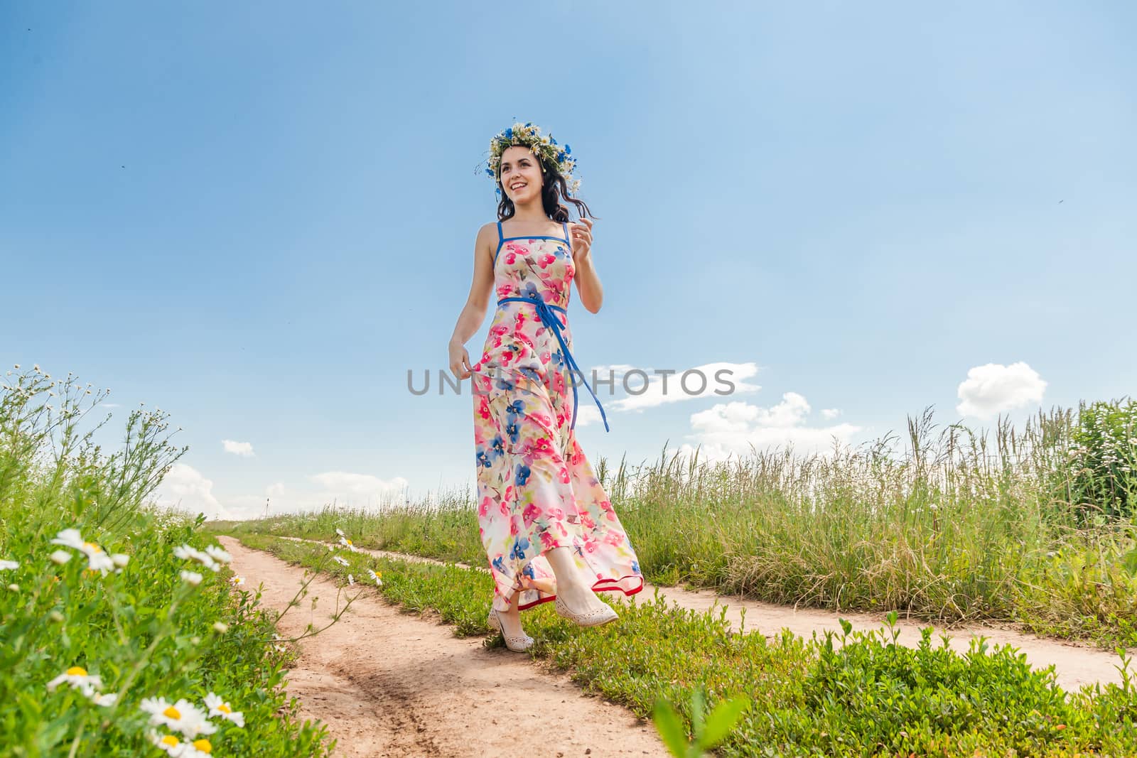 Portrait of the beautiful girl in the field to the utmost
