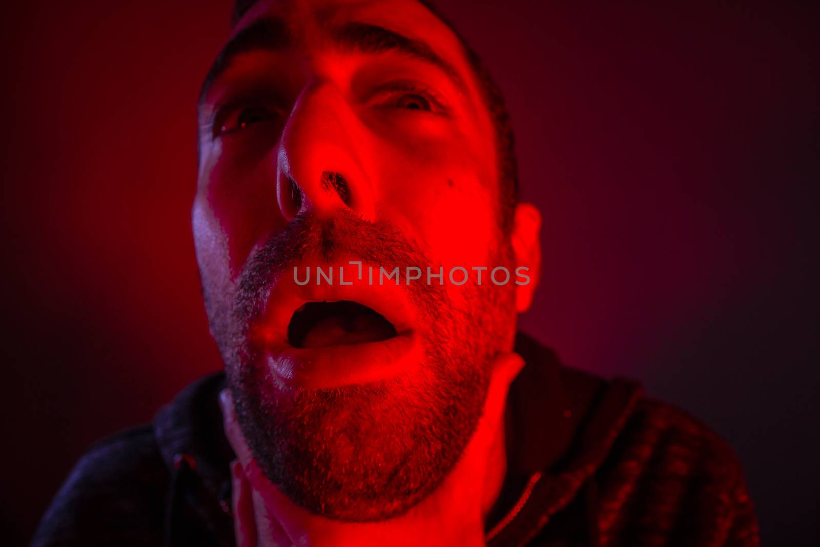 Depressed stressed man strangling himself. Close up headshot portrait of man chokes