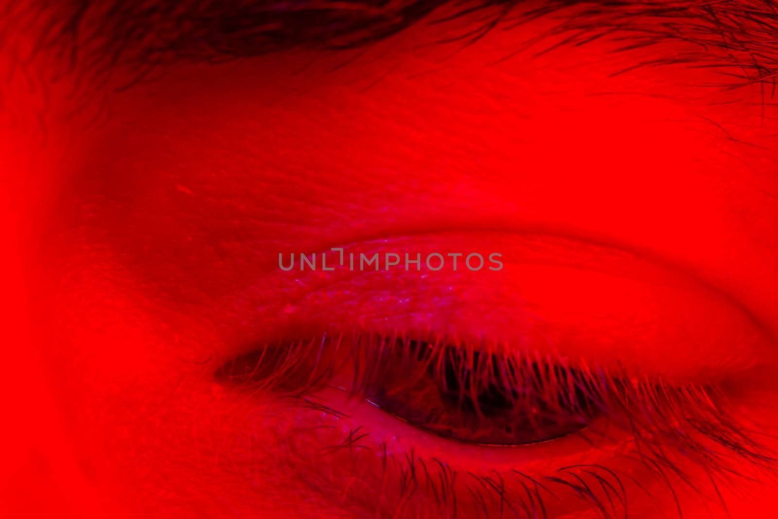 Macro closeup on man eye looking down with sad expression.