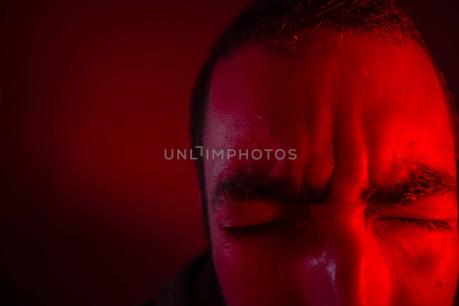 Man is suffering from pain or grief. Close up headshot portrait of man feeling upset or in pain.
