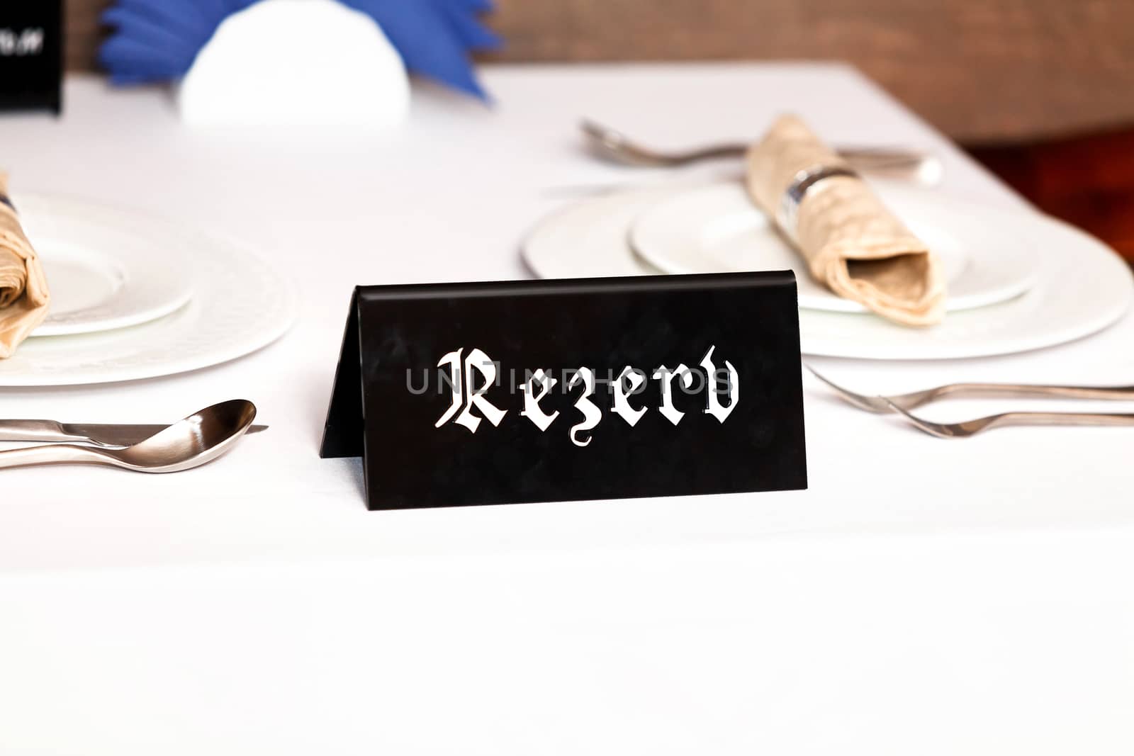 Closeup shot of restaurant reserved table sign by Nobilior