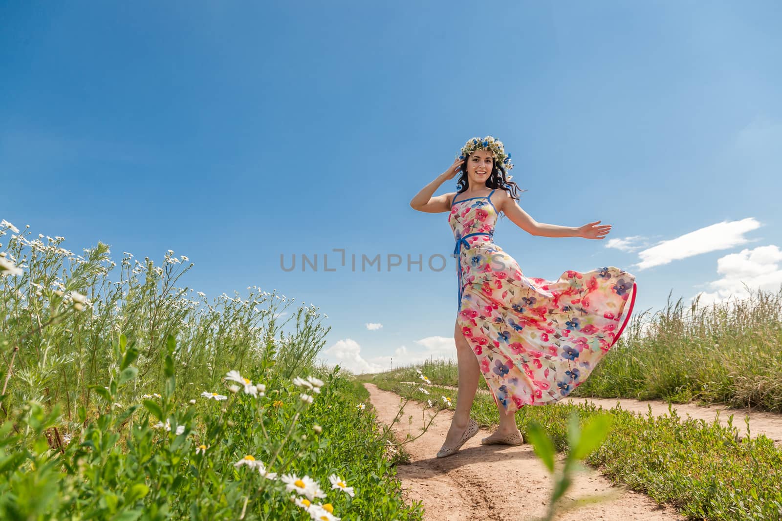 Portrait of the beautiful girl in the field to the utmost