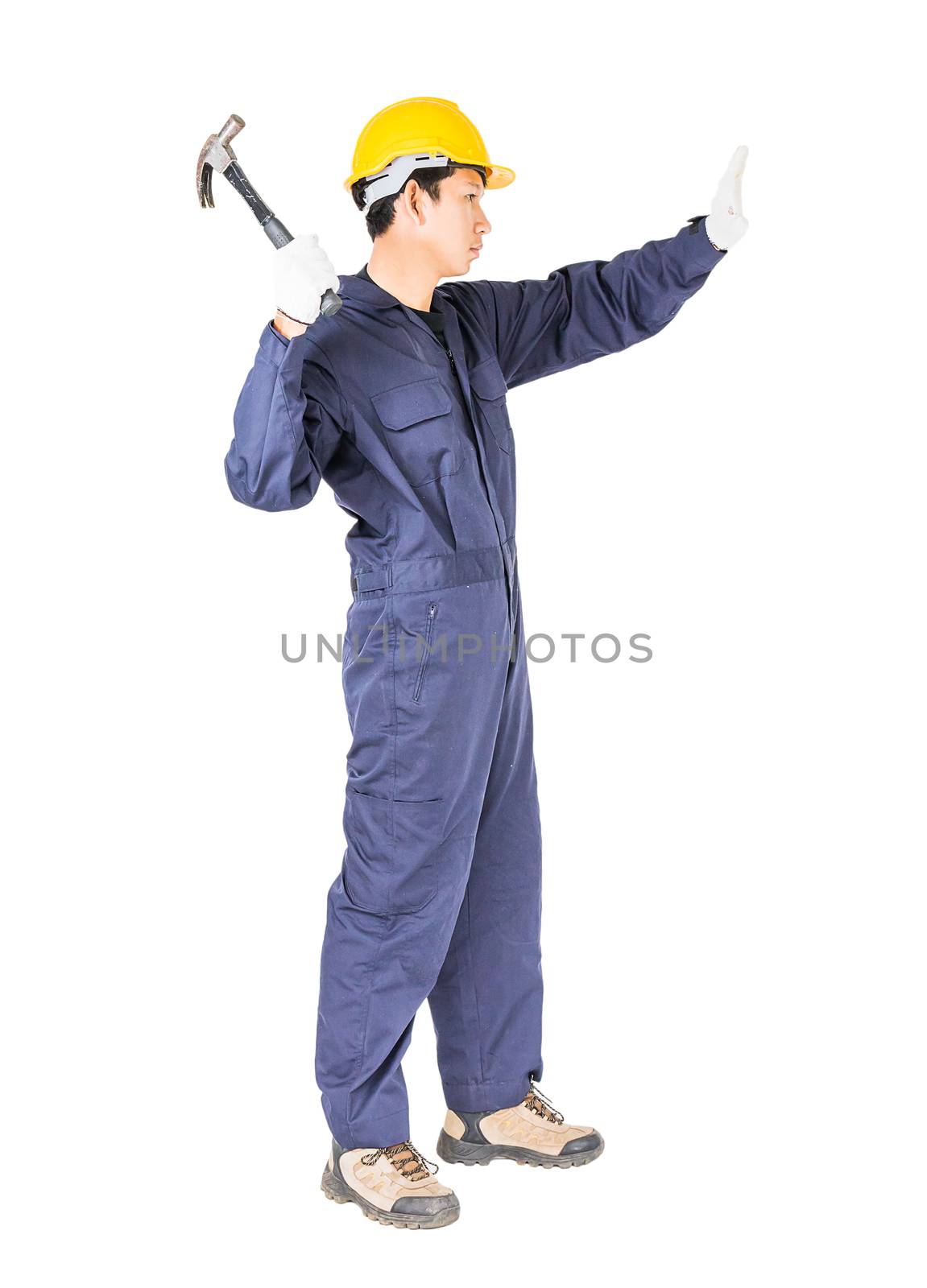 Young handyman in uniform standing with his hammer, Cutout isolated on white background