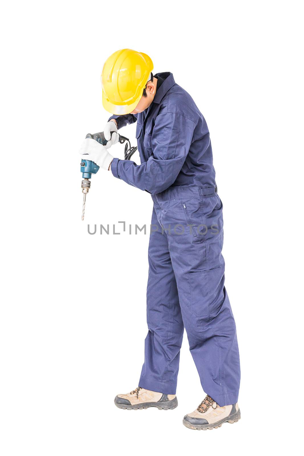 Young handyman in unifrom standing with his electric drill, Cutout isolated on white background