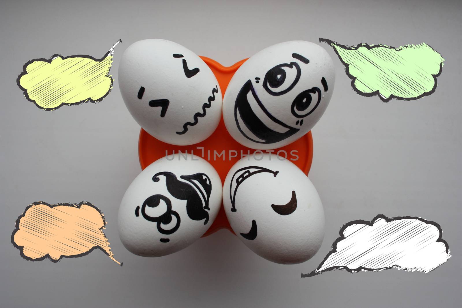 Eggs with a cute face. Photo for your design. Four eggs lie and look up. Concept: family vacation. Cloud of thought is white. Place under the text.