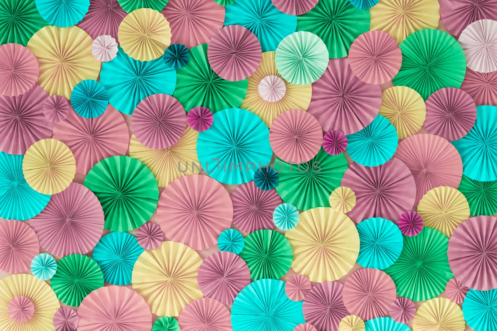 Colorful celebration background wall with multicolored paper circles of pink, lilac, yellow, green and blue colors
