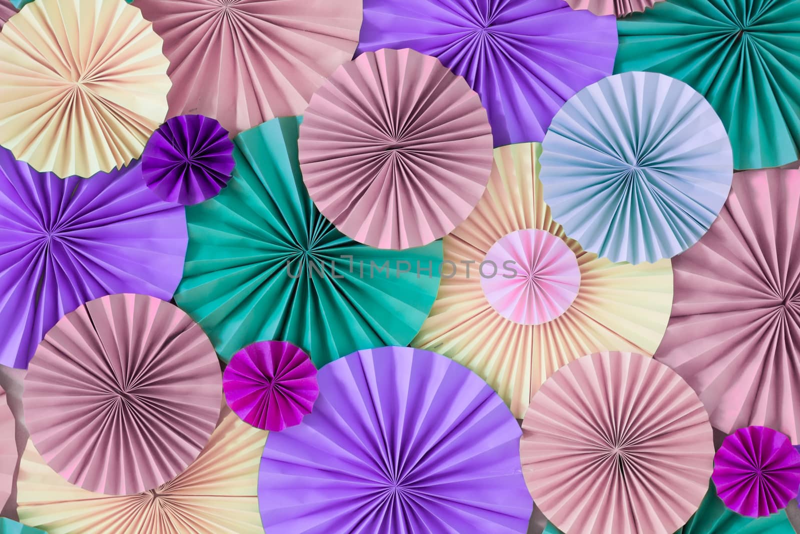 Romantic colorful celebration background wall with multicolored paper circles of pink, lilac, purple, green and beige colors