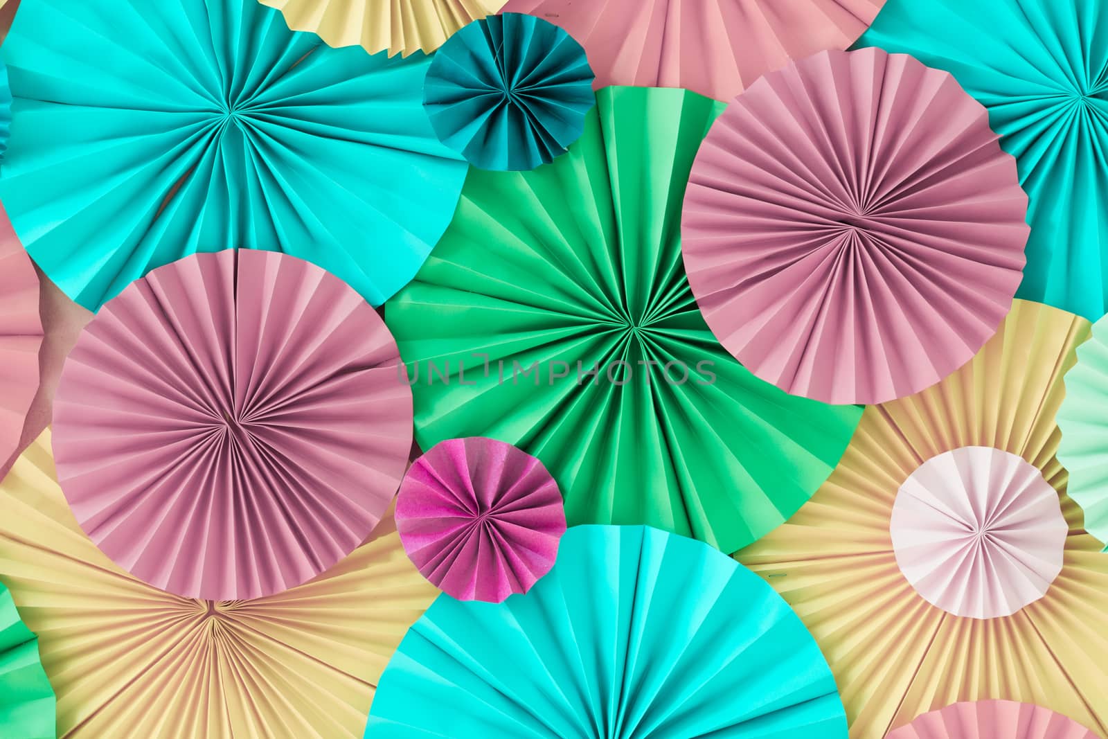 Colorful celebration background wall with multicolored paper circles of pink, lilac, yellow, green and blue colors