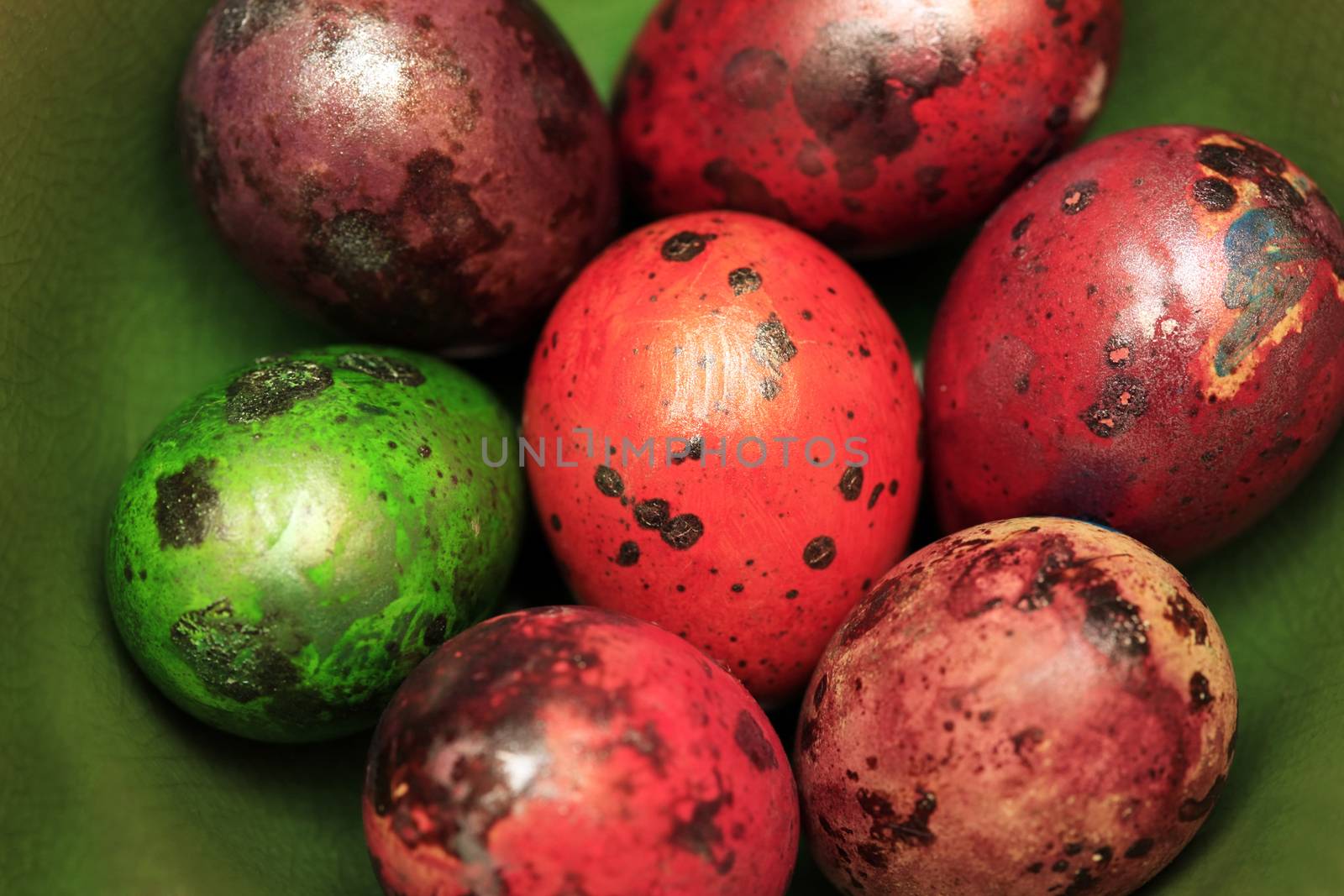 Colorful Speckled Easter Egg on Green Background