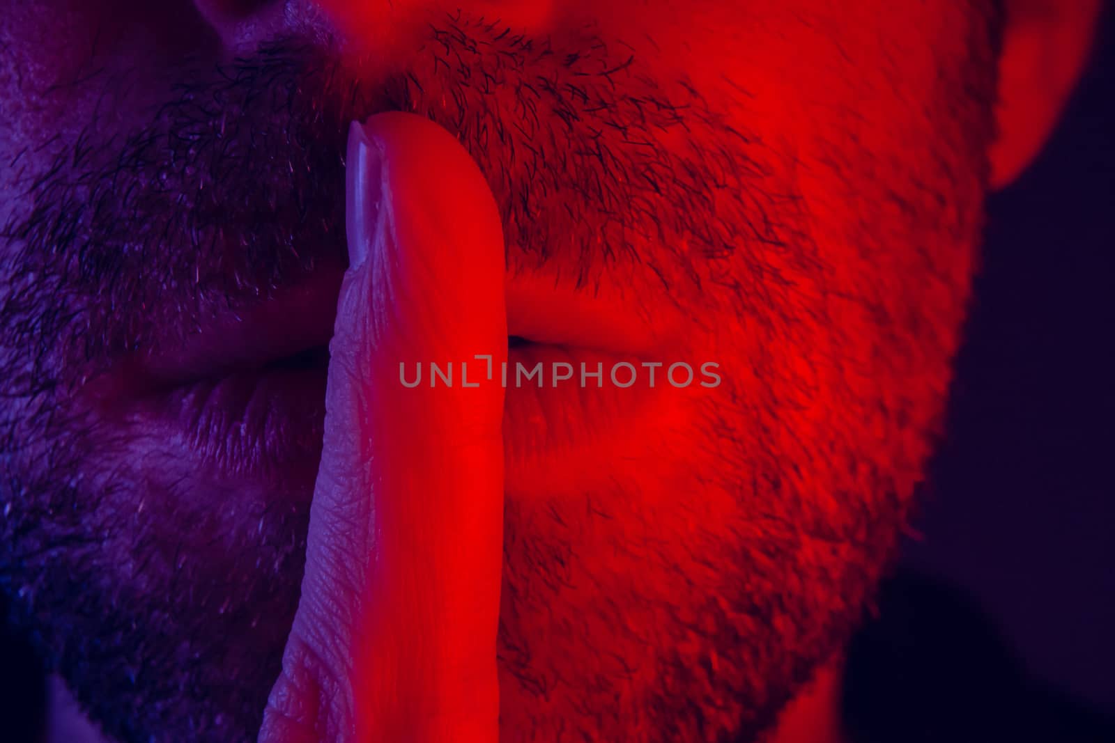 Macro close up on man with seductive facial expression holding f by wavemovies