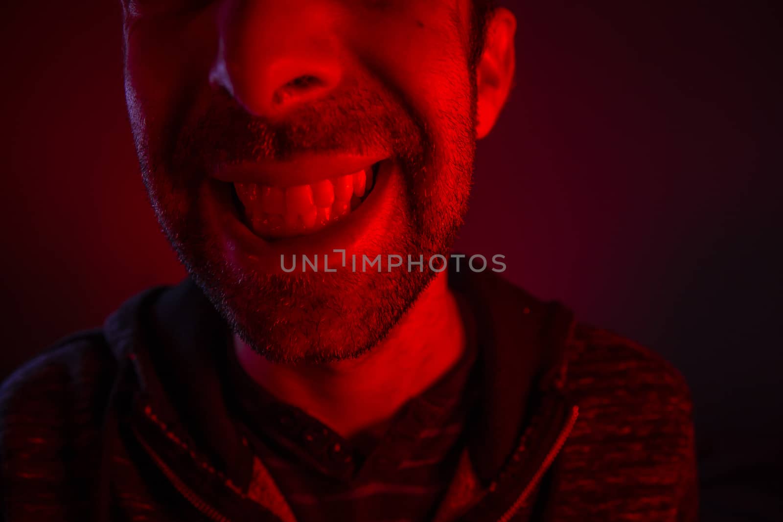 Man with happy smiling facial expression. Close up portrait of happy young man looking at camera.