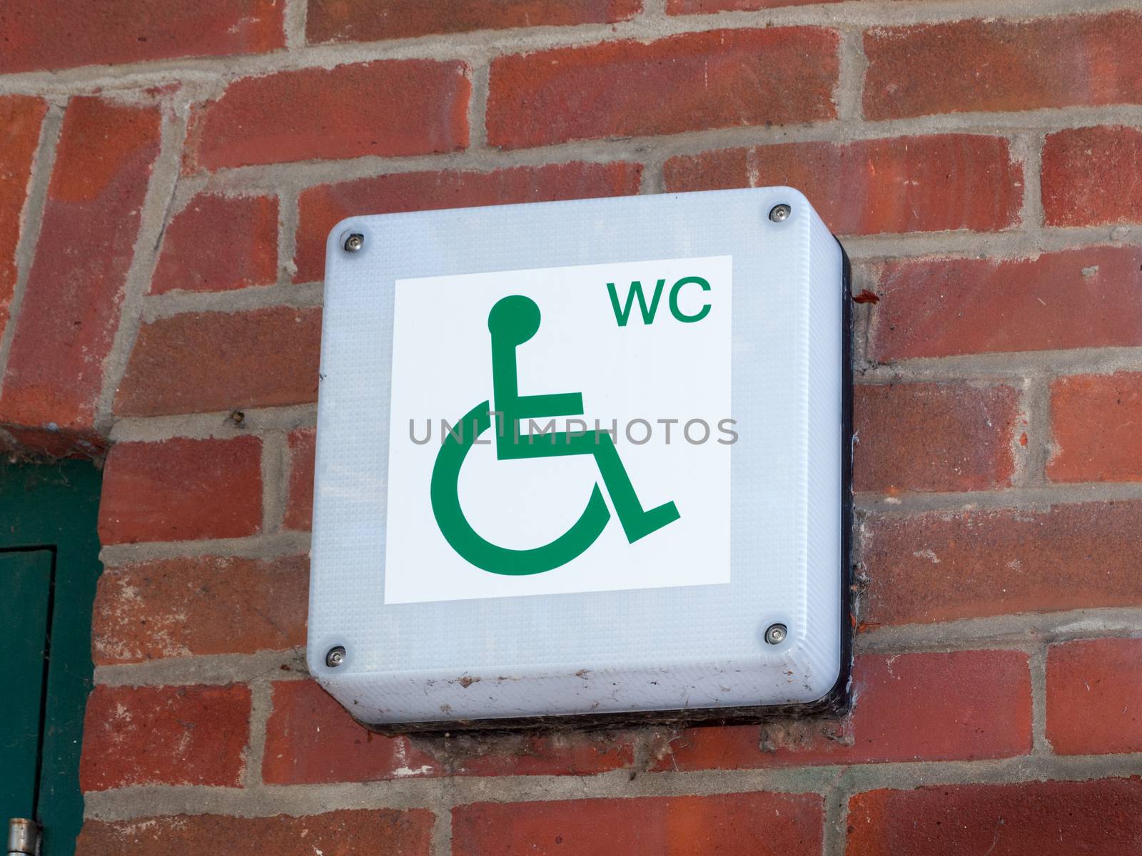 disabled wc toilet water closet sign outside on brick wall close up; essex; england; uk