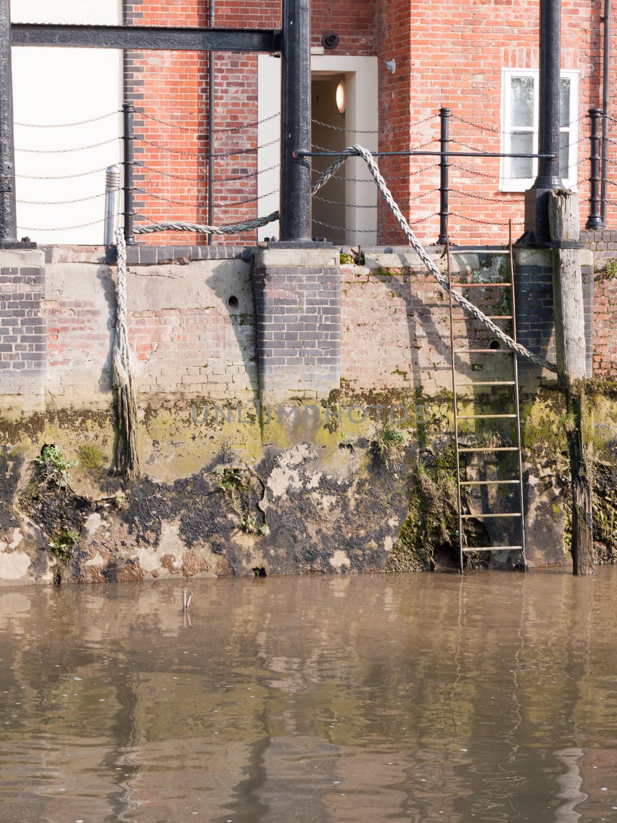 ladder at side of river docks scene outside water no people empty; essex; england; uk