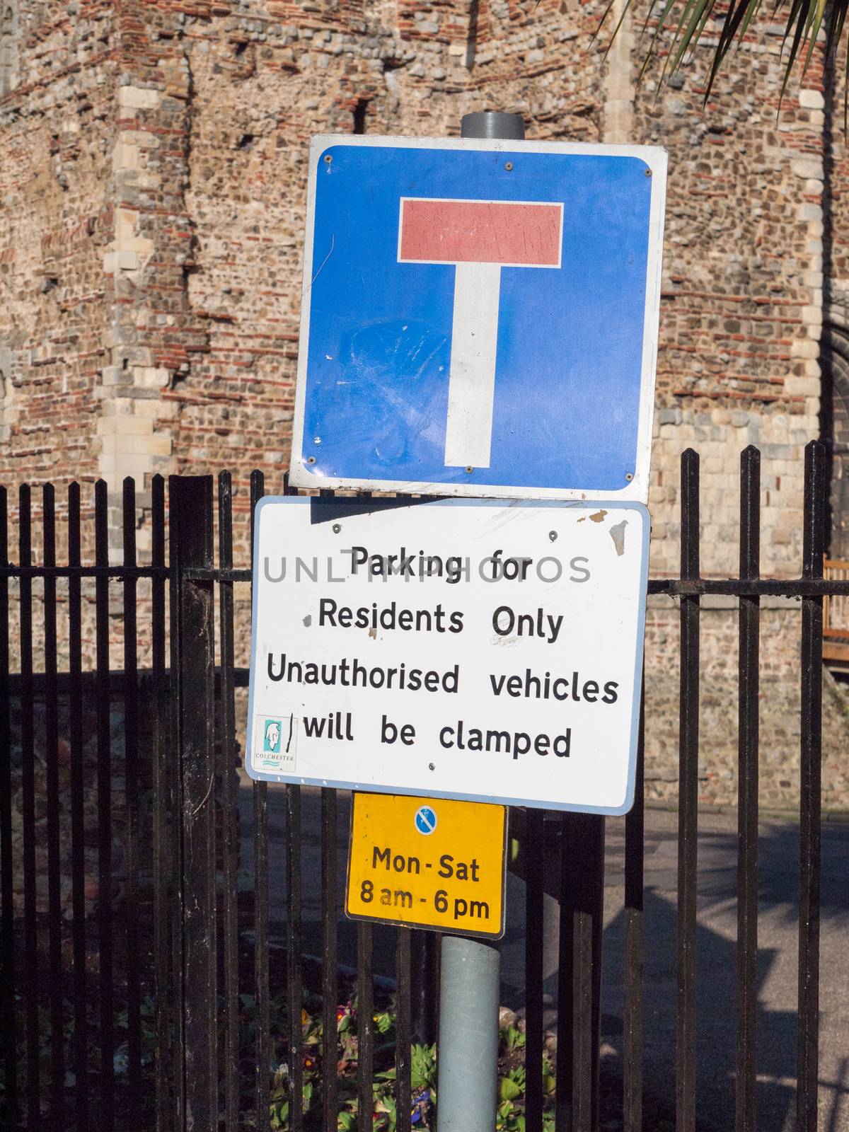 road sign parking for residents only unauthorised vehicles will be clamped; essex; england; uk