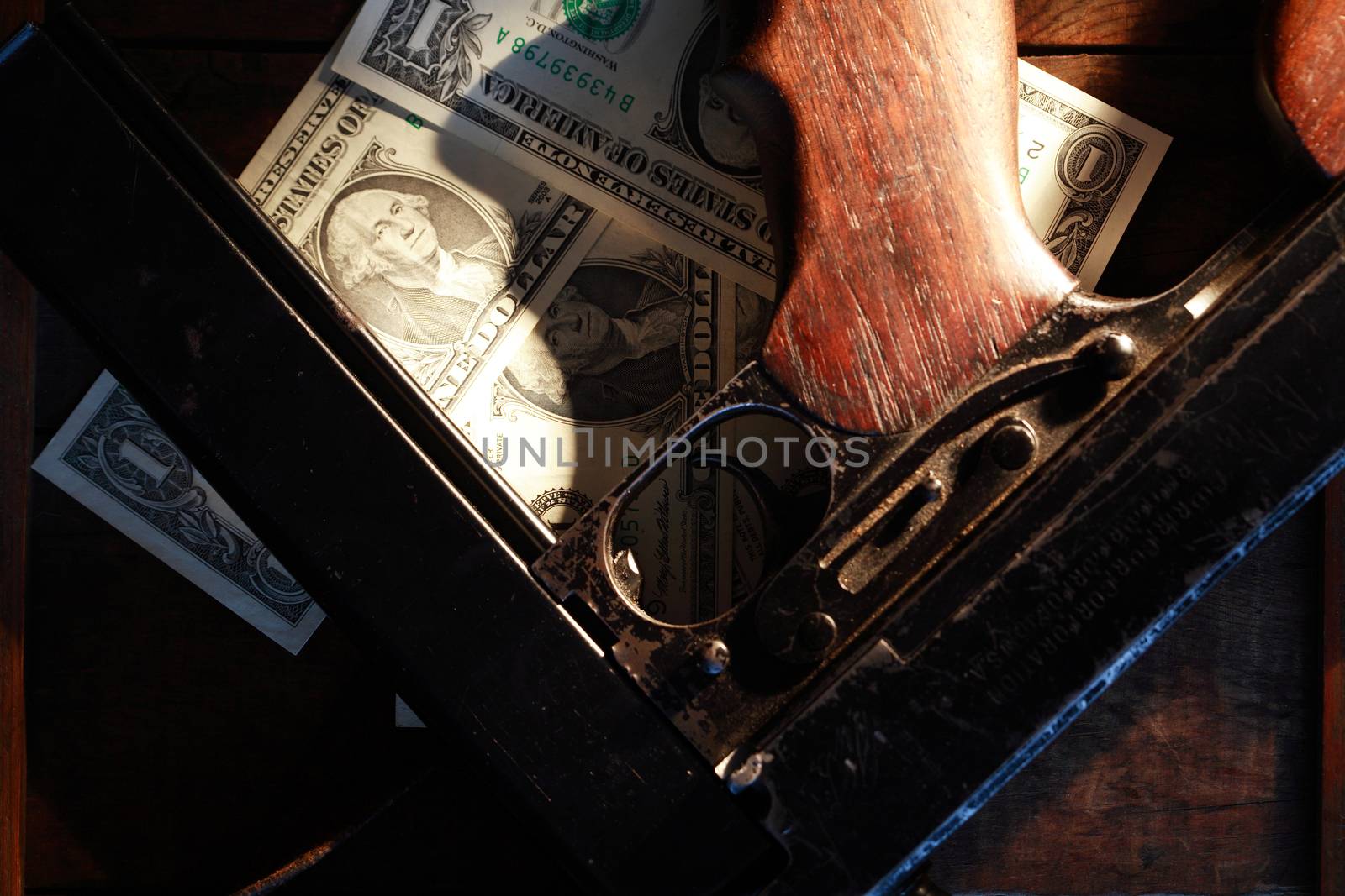 Old USA submachine gun closeup near one dollar bank notes