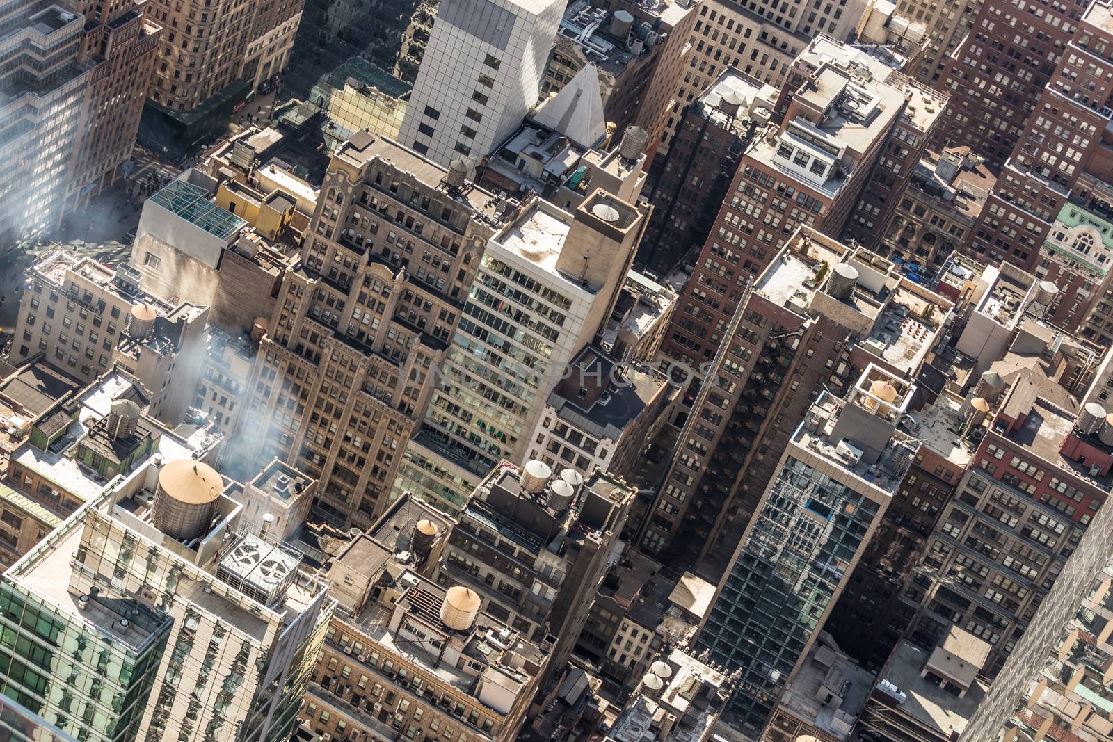 New York City, USA. Midtown Manhattan building rooftops with steam comming from the heating systems.