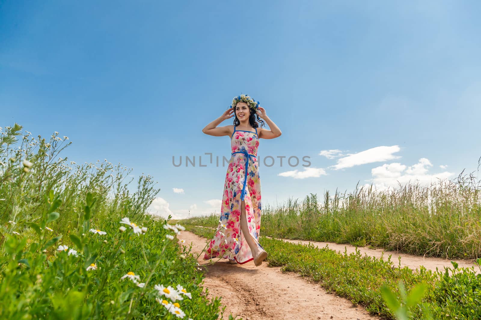 Portrait of the beautiful girl in the field to the utmost
