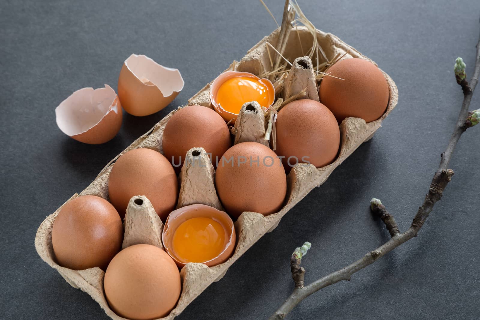 chicken eggs in a cardboard grate on a gray background