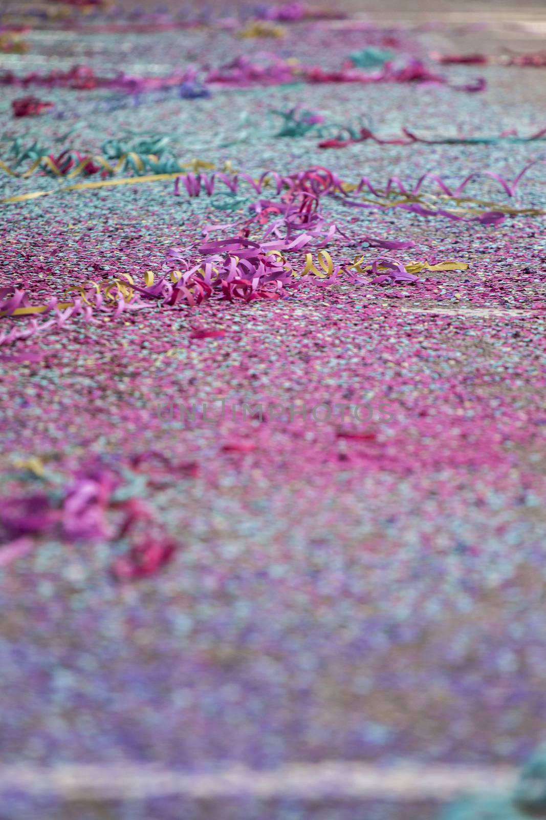 Close up view of Carnival confetti and paper ribbon on the ground.