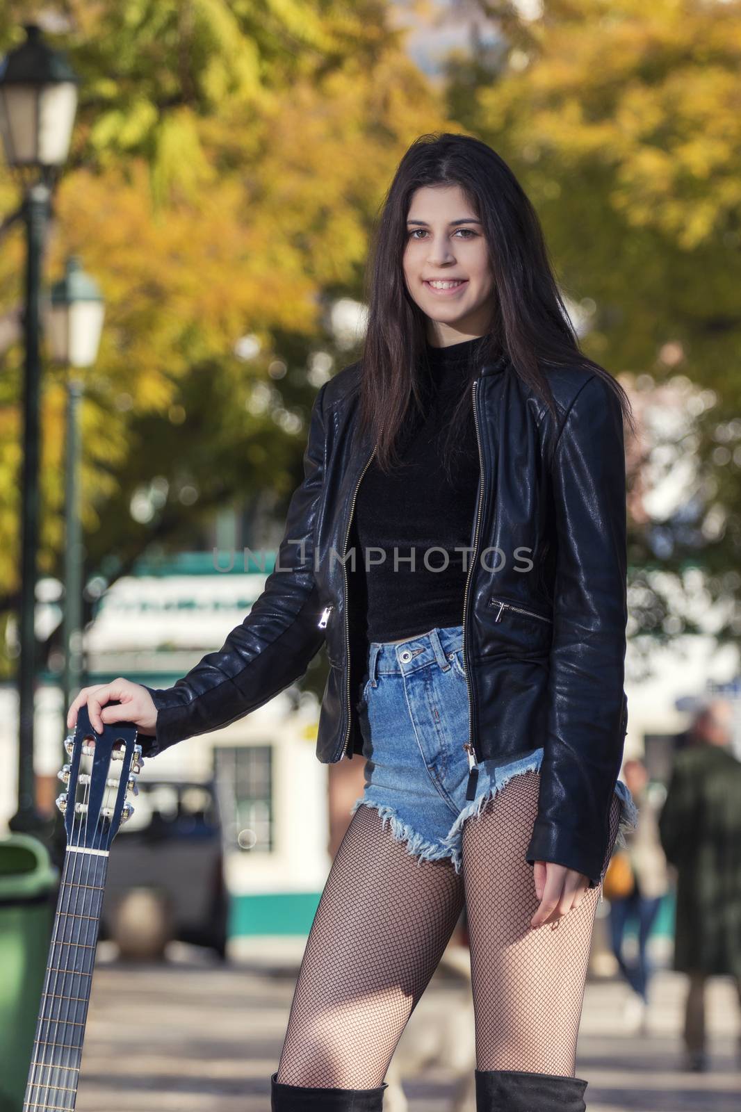 Young woman with classic guitar by membio