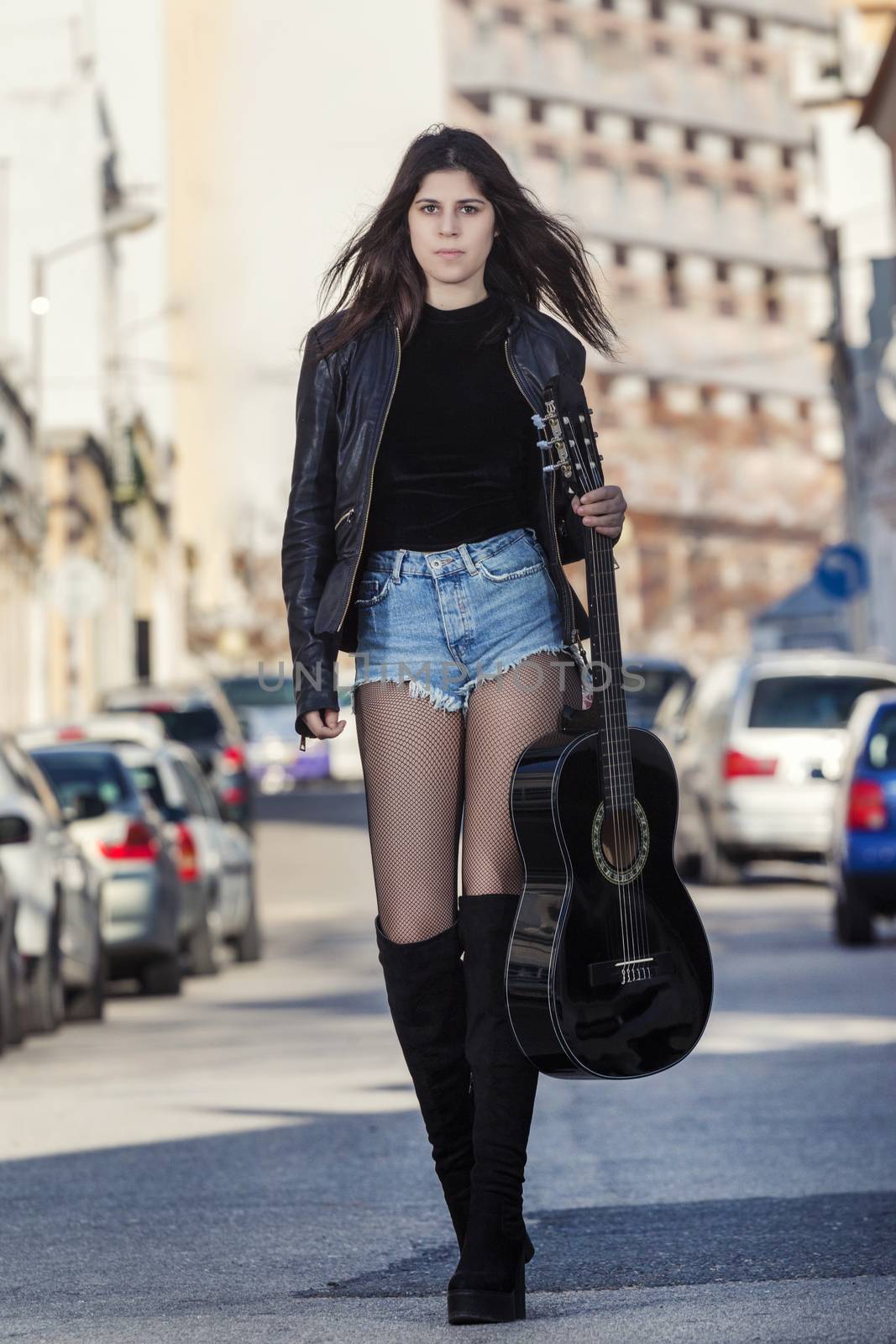 Young woman with classic guitar by membio