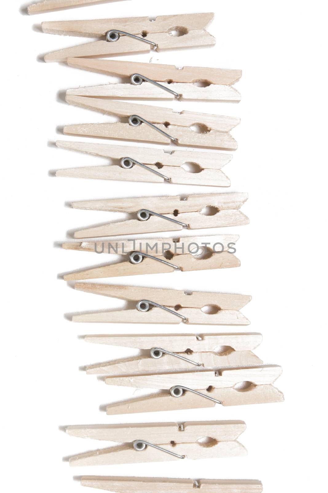 Aligned clothing pegs isolated on a white background.