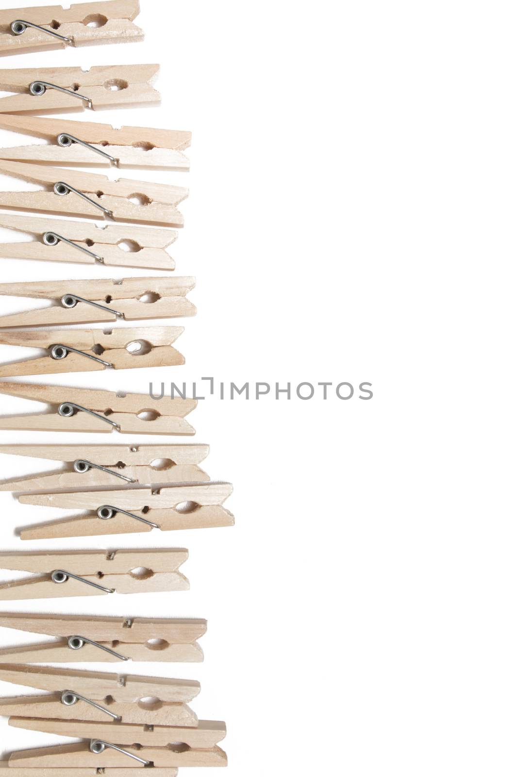 Aligned clothing pegs isolated on a white background.