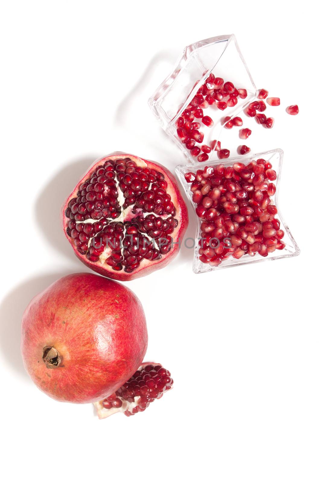 Close up view of tasty pommegranate fruit isolated on a white background.