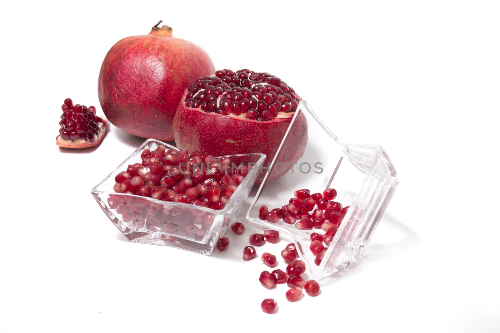 Close up view of tasty pommegranate fruit isolated on a white background.