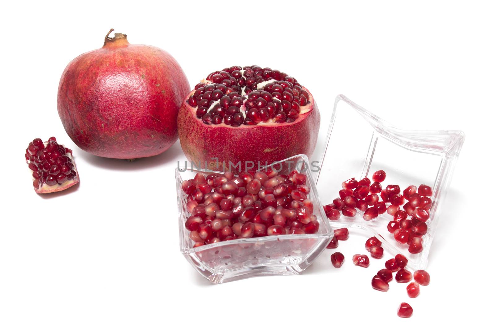 Close up view of tasty pommegranate fruit isolated on a white background.