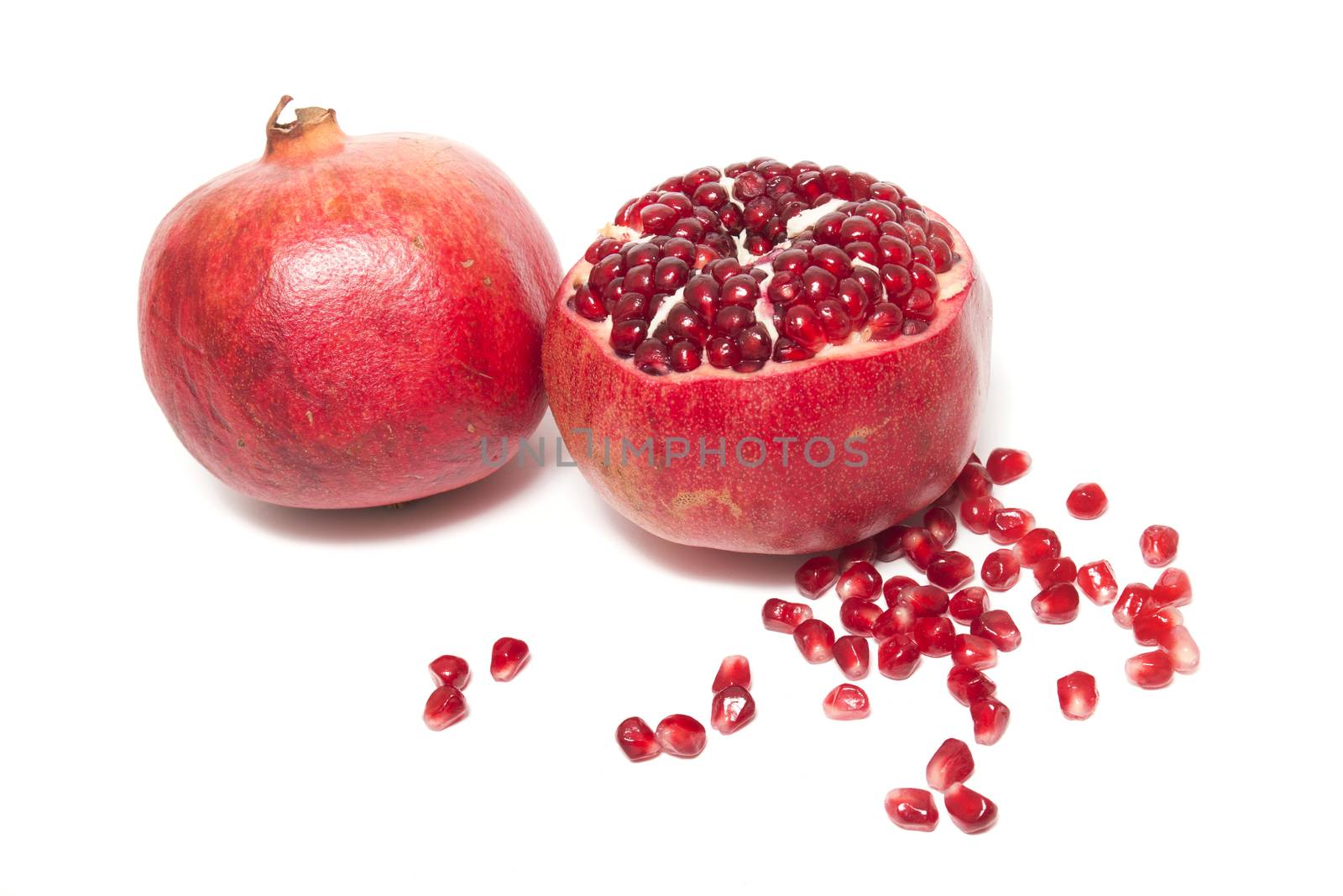 Close up view of tasty pommegranate fruit isolated on a white background.