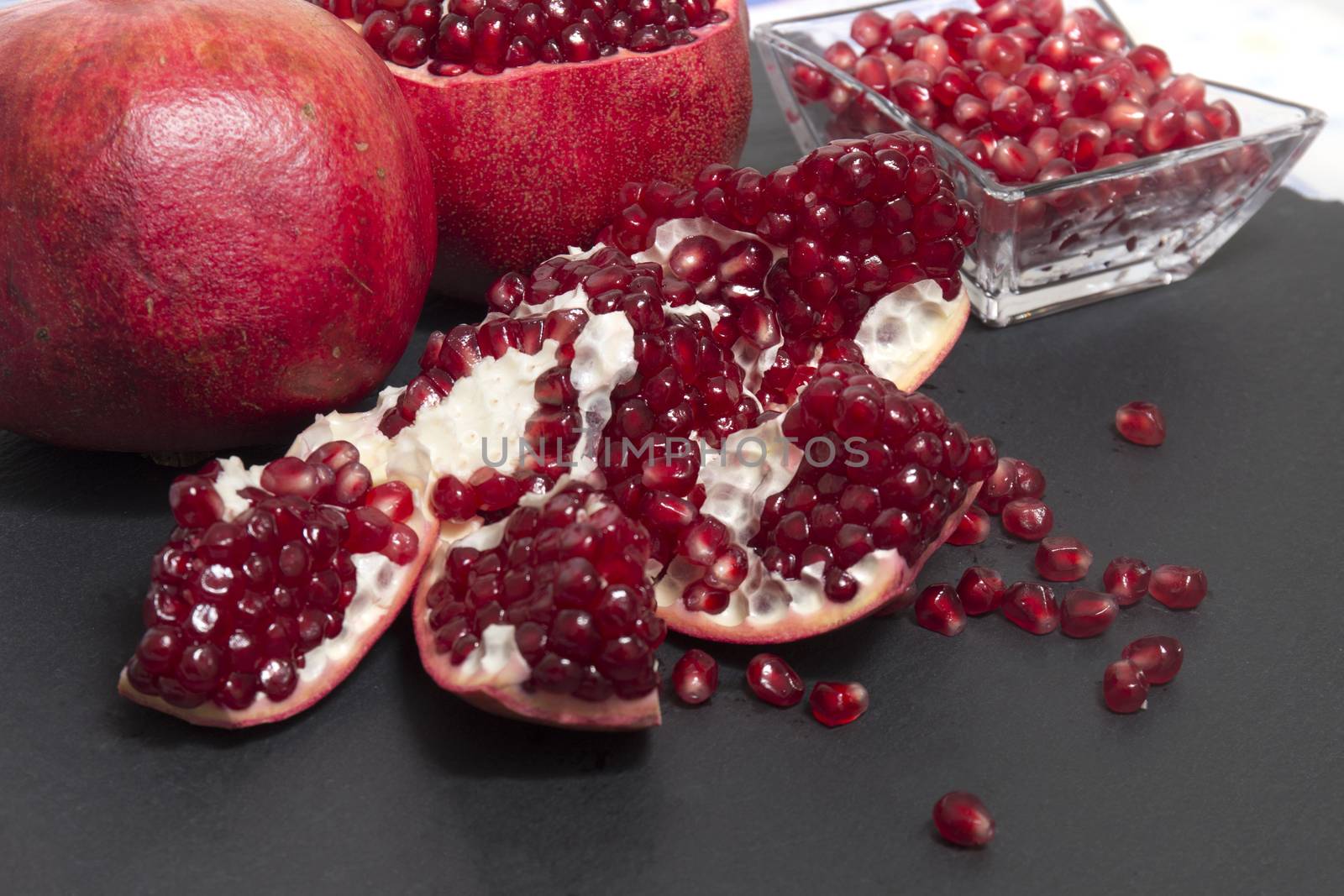 Close up view of tasty pommegranate fruit on top of a slate stone.