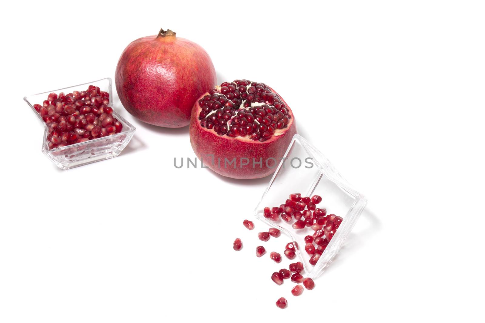 Close up view of tasty pommegranate fruit isolated on a white background.