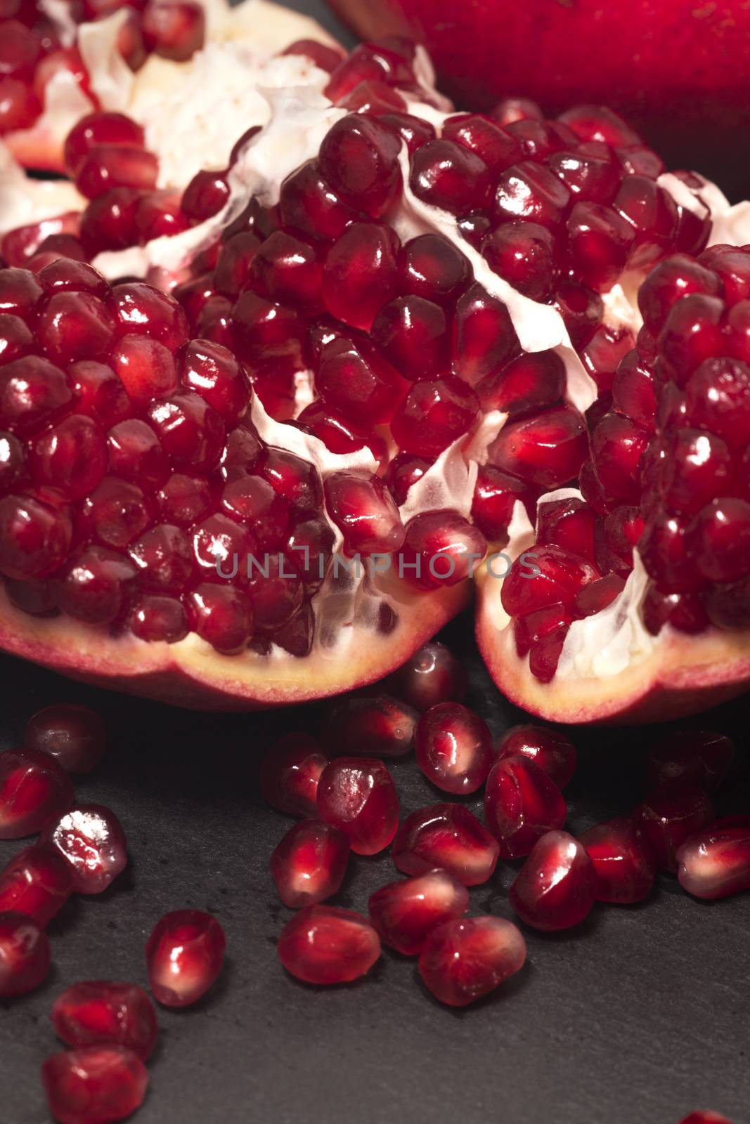 Close up view of tasty pommegranate fruit on top of a slate stone.