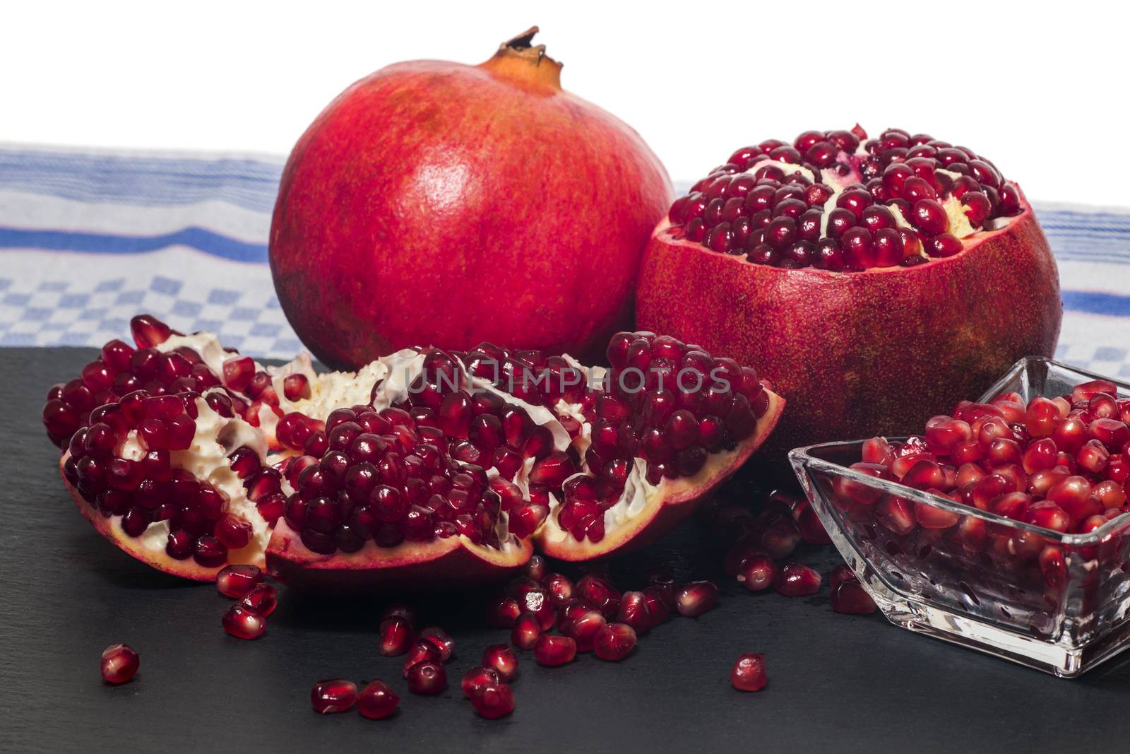 Close up view of tasty pommegranate fruit on top of a slate stone.