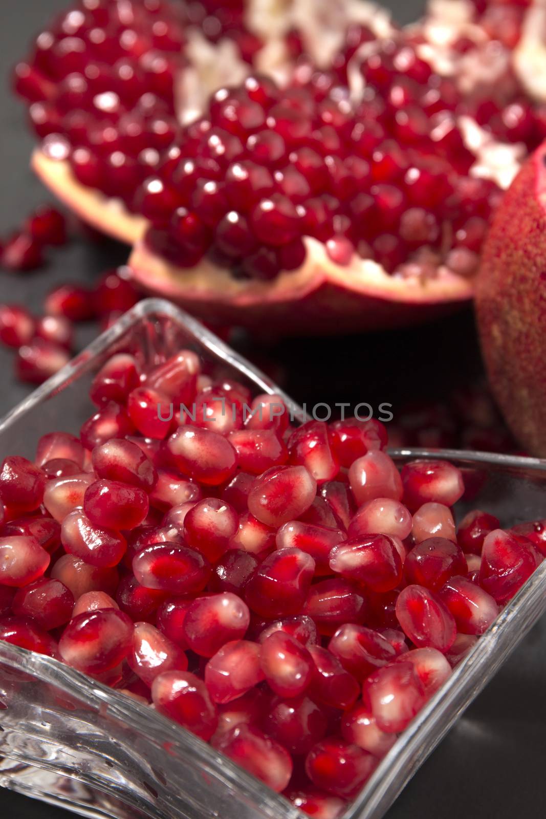 Close up view of tasty pommegranate fruit on top of a slate stone.